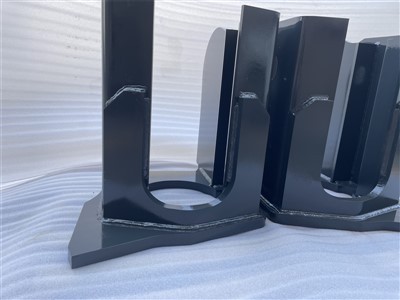 What are the main components of an excavator chassis?